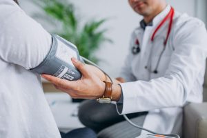 young-male-psysician-with-patient-measuring-blood-pressure-1-2048x1365